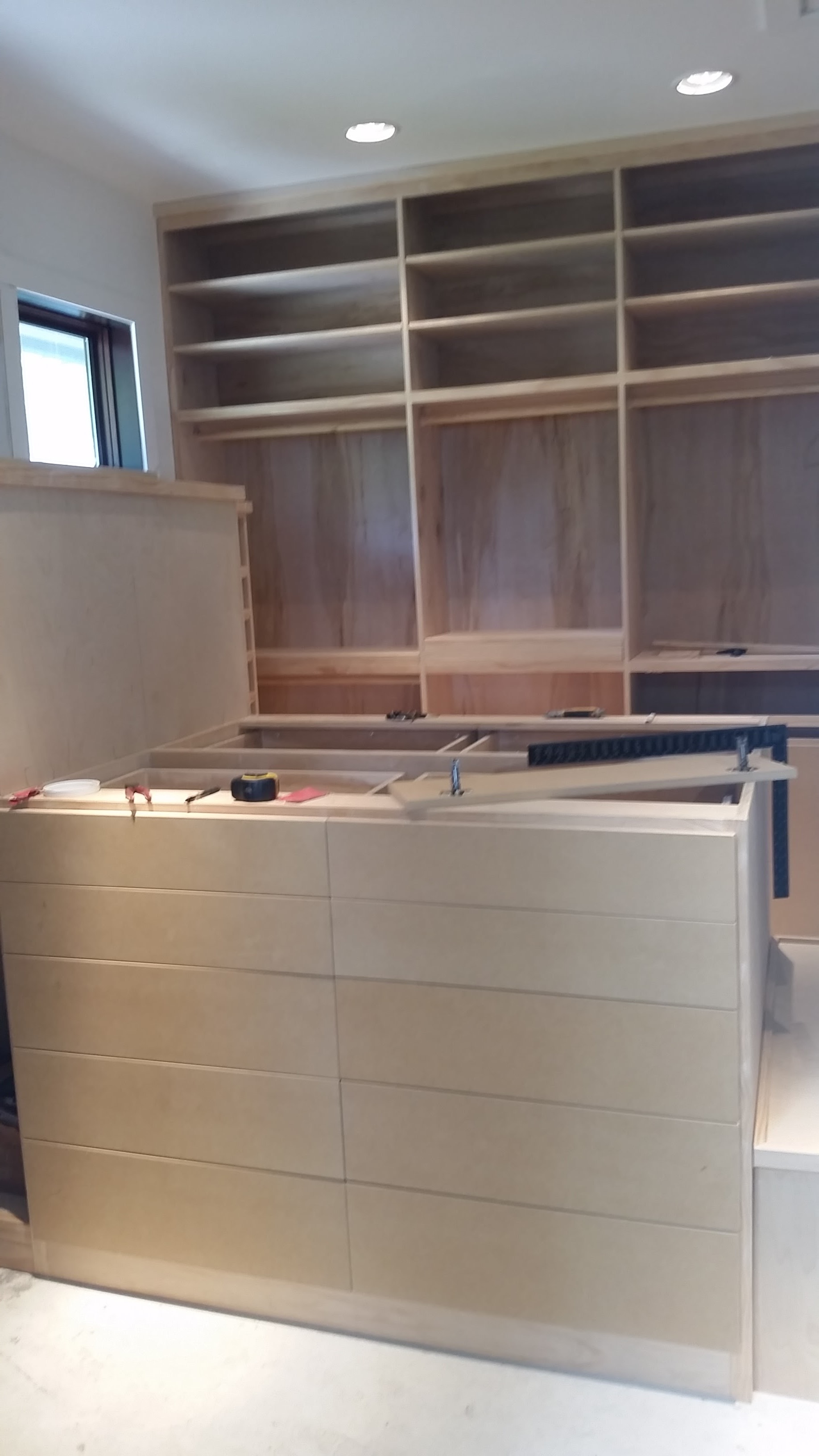 Custom built-in shelving and cabinet carcasses assembled during installation