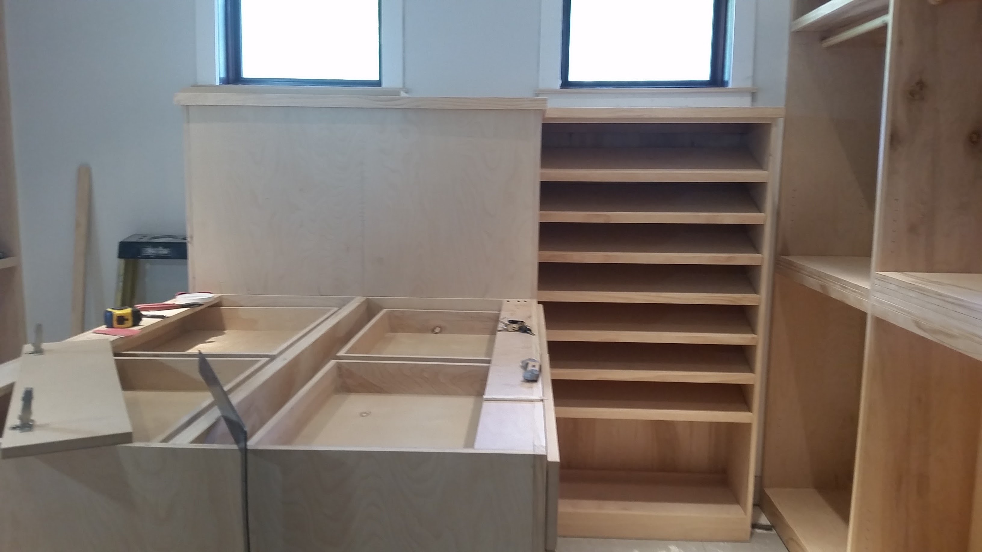 Custom closet cabinetry with shelving tower and drawer inserts being assembled