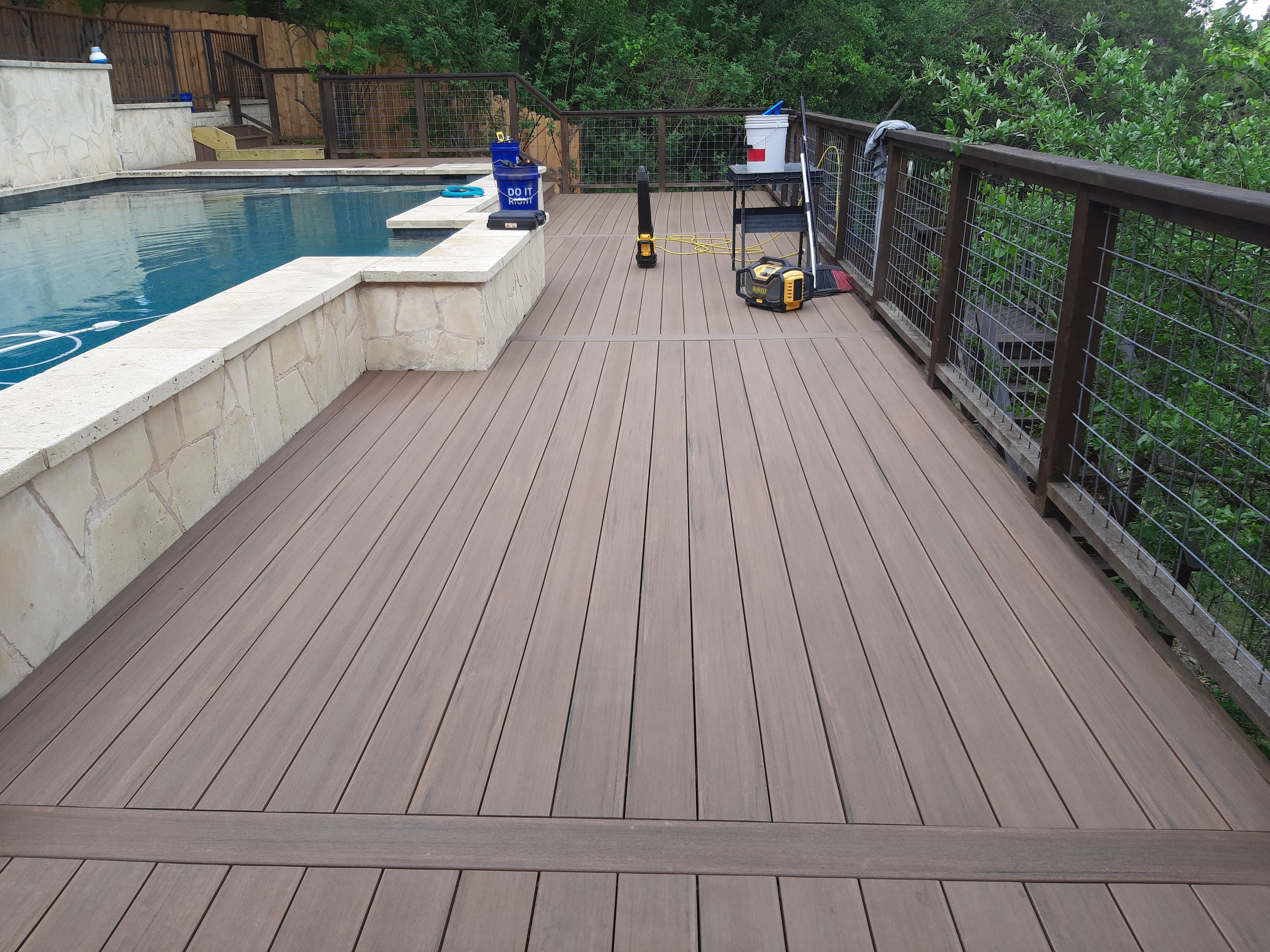 Finished composite deck ceiling boards viewed from below beside pool