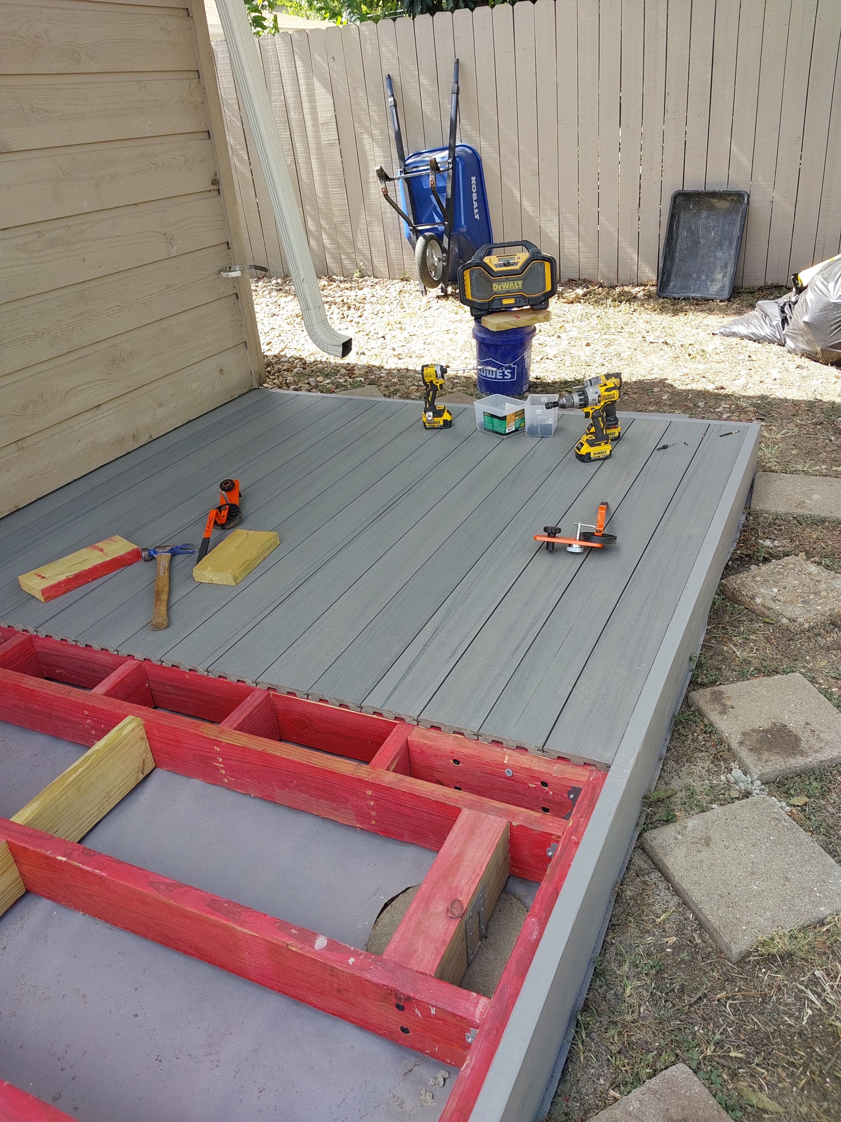 Gray composite deck installation in progress with tools on surface