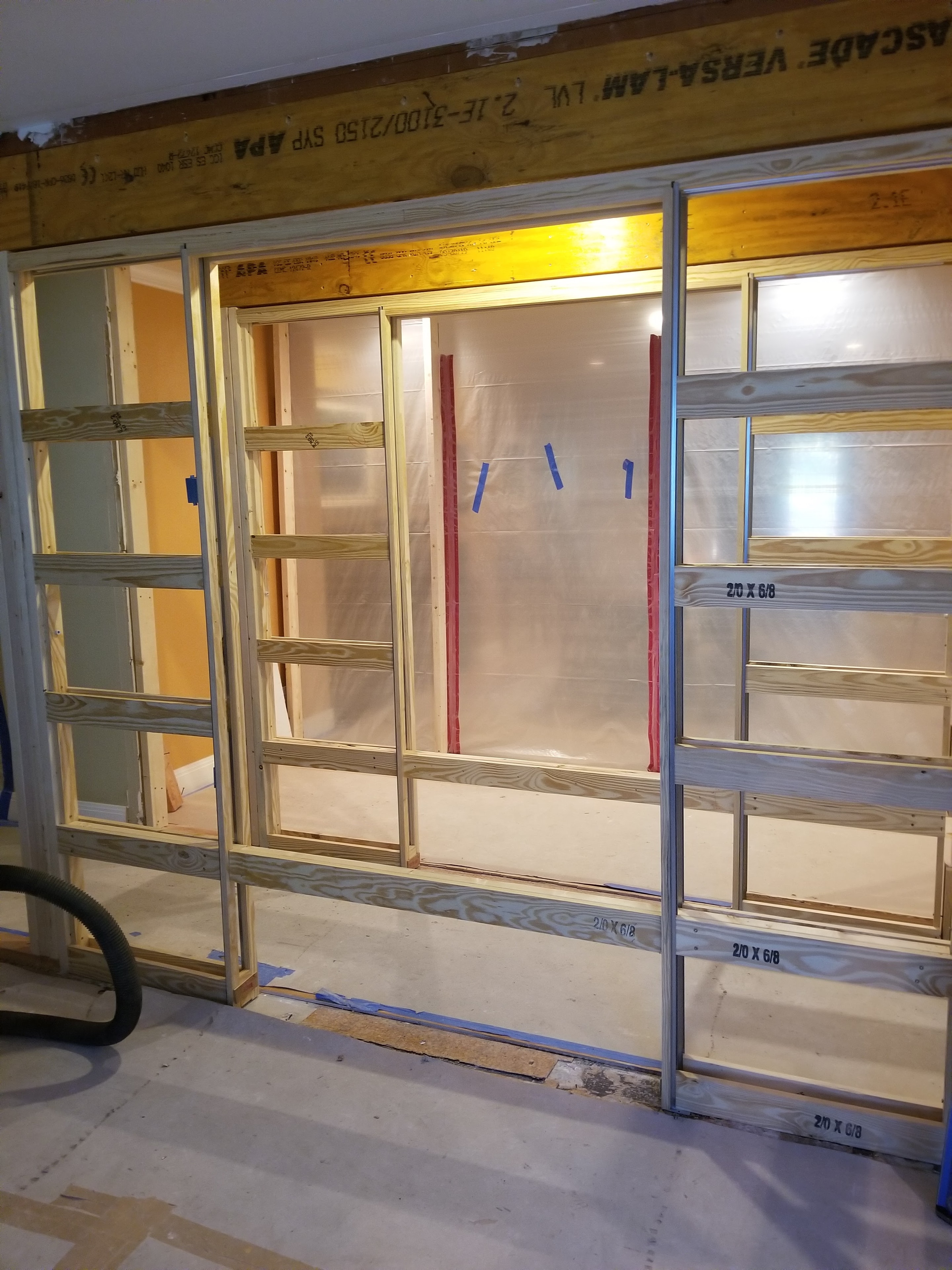 Interior wall framing with LVL beam and window rough openings during remodel