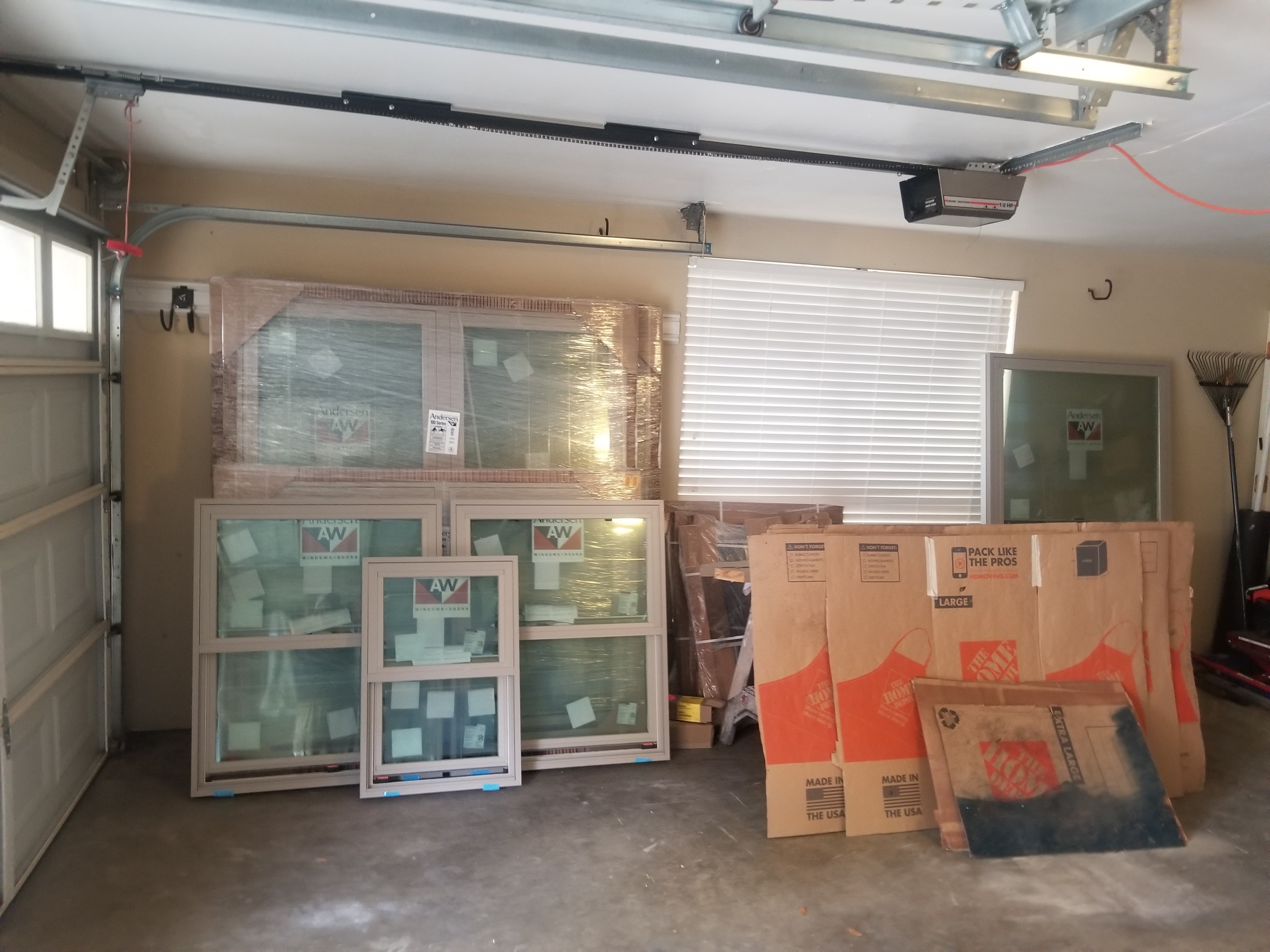 Andersen window units staged in garage ready for installation