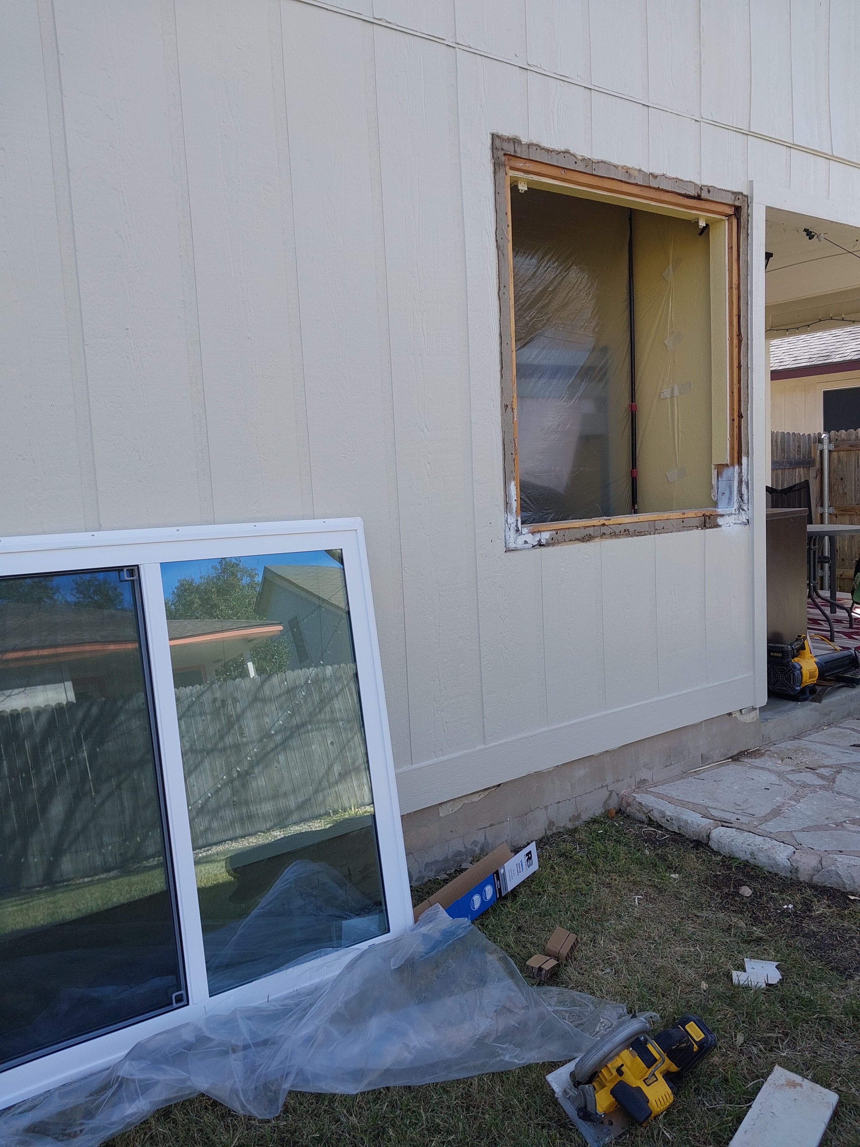 Window replacement in progress with opening prepped and new unit ready