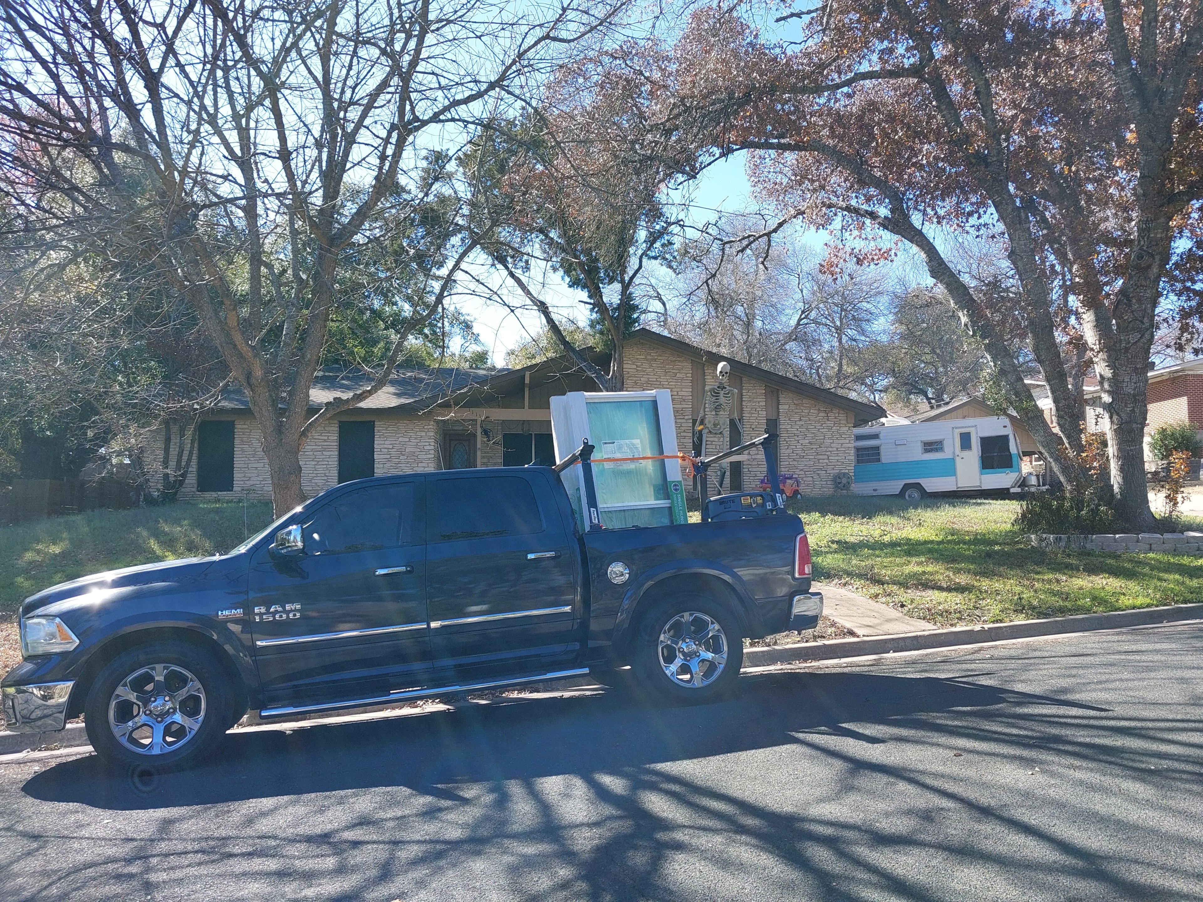 Truck delivering large window unit to residential job site